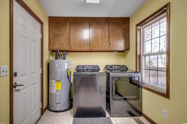 laundry room featuring visible vents, washer and clothes dryer, water heater, light tile patterned floors, and cabinet space