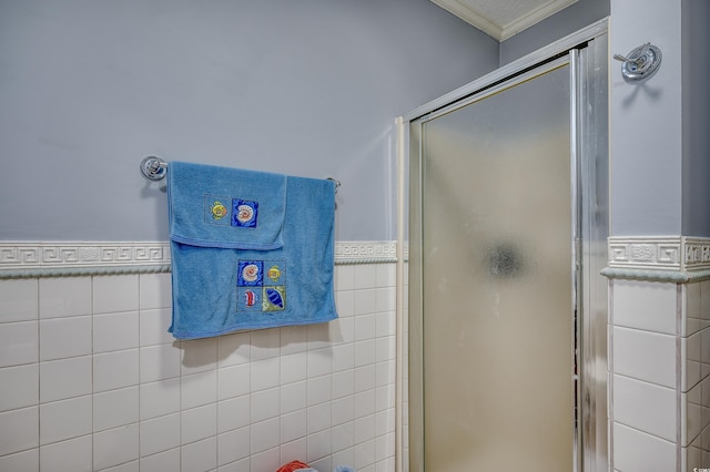 full bathroom with a shower stall, tile walls, and wainscoting