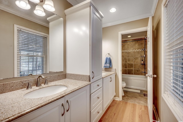 full bathroom with wood finished floors, toilet, vanity, and ornamental molding