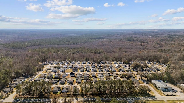 drone / aerial view featuring a forest view and a residential view