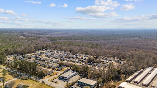 drone / aerial view with a residential view and a view of trees