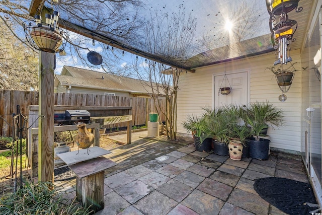 view of patio / terrace featuring grilling area and fence