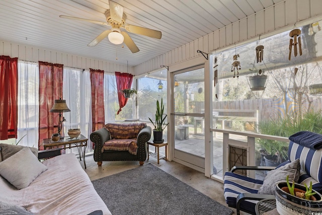 sunroom / solarium featuring plenty of natural light and a ceiling fan