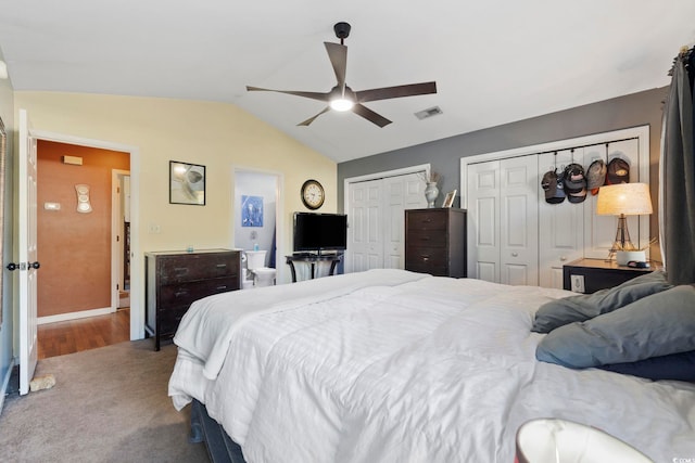 bedroom featuring visible vents, two closets, a ceiling fan, carpet, and lofted ceiling