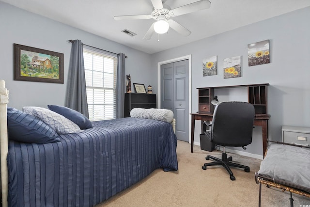 bedroom featuring visible vents, light carpet, a ceiling fan, a closet, and baseboards