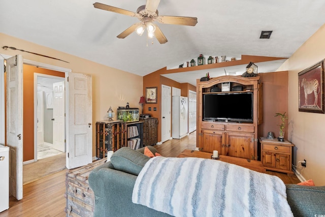 living room with lofted ceiling, a ceiling fan, light wood-type flooring, and baseboards