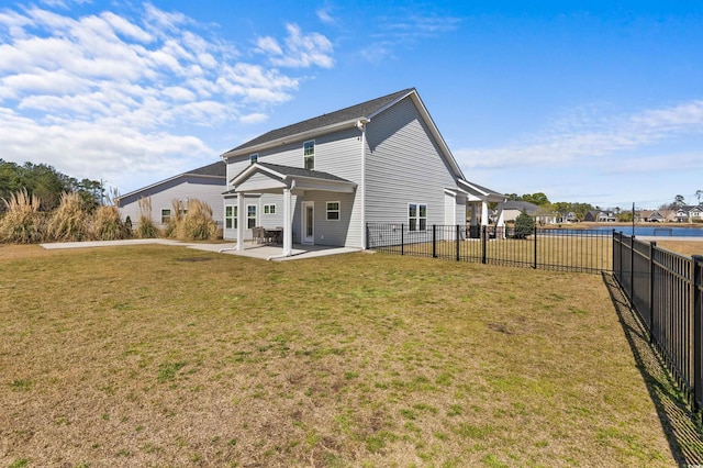 back of house featuring a lawn, a patio, and fence