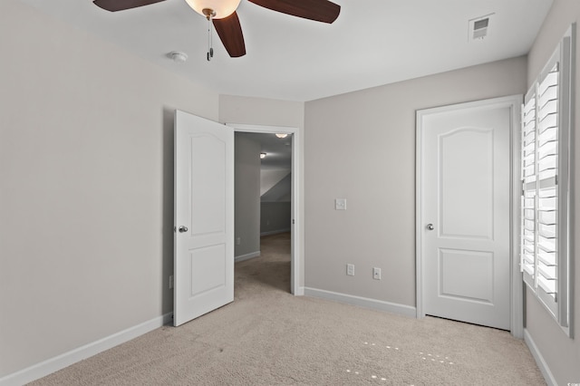 unfurnished bedroom featuring visible vents, carpet flooring, a ceiling fan, and baseboards