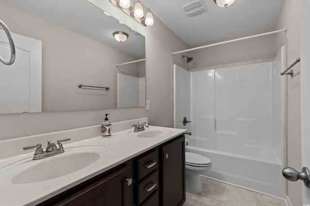 bathroom with double vanity, toilet, visible vents, and a sink