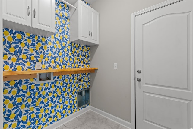 clothes washing area featuring washer hookup, cabinet space, baseboards, and tile patterned flooring