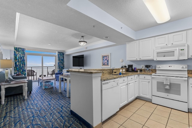2201 S Ocean Blvd Unit 1707, Myrtle Beach, SC 29577 - kitchen with white appliances, a textured ceiling, a peninsula, open floor plan, and a sink