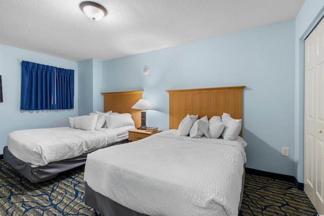 2201 S Ocean Blvd Unit 1707, Myrtle Beach, SC 29577 - bedroom with a closet, dark carpet, and a textured ceiling