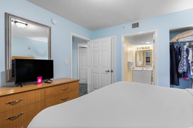 2201 S Ocean Blvd Unit 1707, Myrtle Beach, SC 29577 - bedroom featuring a textured ceiling, a closet, and ensuite bath