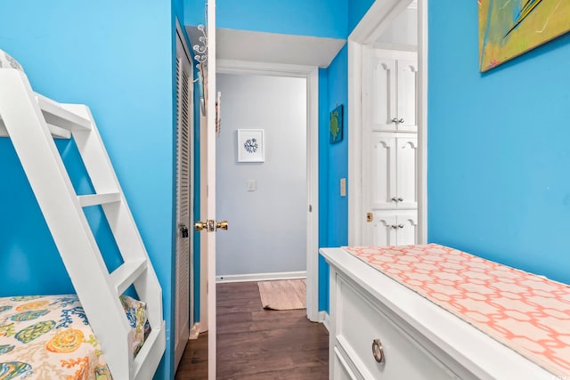 bedroom featuring dark wood-type flooring and baseboards