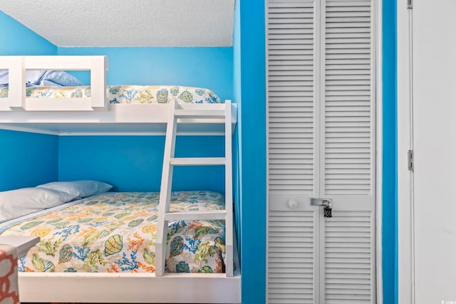 bedroom with a closet and a textured ceiling