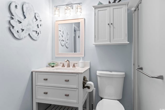 bathroom with toilet and vanity