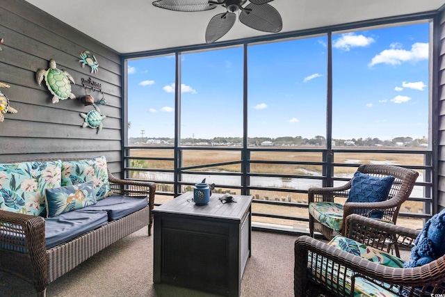 sunroom featuring ceiling fan