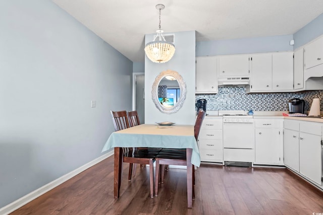 kitchen with under cabinet range hood, baseboards, tasteful backsplash, and white electric range