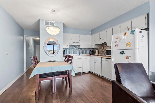 kitchen featuring tasteful backsplash, an inviting chandelier, white appliances, white cabinetry, and dark wood-style flooring