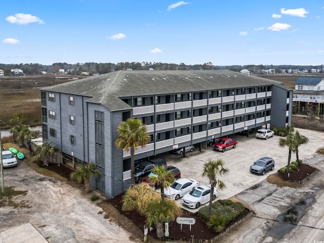 view of building exterior with uncovered parking