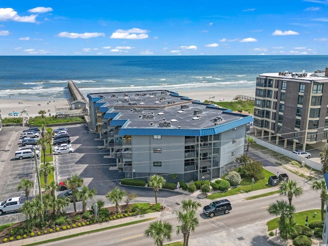 drone / aerial view with a beach view and a water view