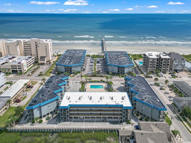 birds eye view of property with a view of the beach and a water view