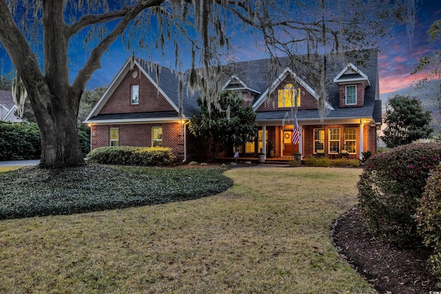 view of front of home with a front yard and brick siding