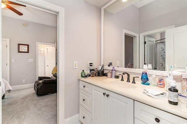 full bath with baseboards, vanity, ensuite bath, and a ceiling fan