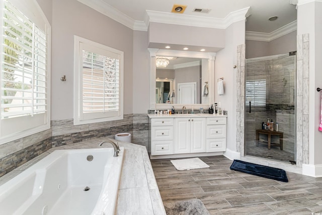 full bathroom with vanity, visible vents, a whirlpool tub, a shower stall, and crown molding