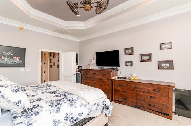 bedroom featuring visible vents, crown molding, a tray ceiling, and carpet floors