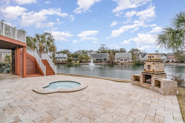 view of pool featuring a water view, a patio, and stairs