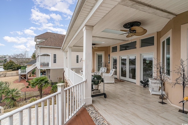 view of patio with stairway, a ceiling fan, and fence