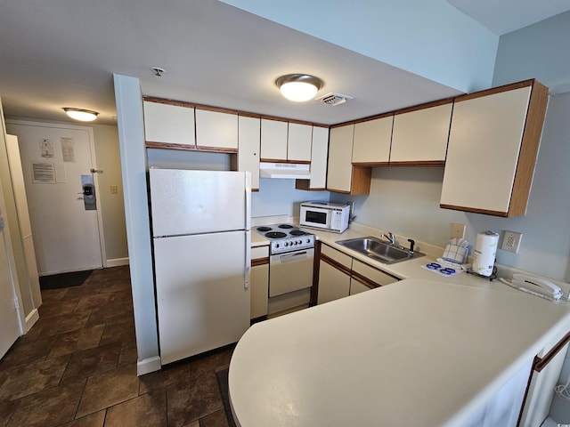 kitchen featuring visible vents, a sink, white appliances, light countertops, and extractor fan