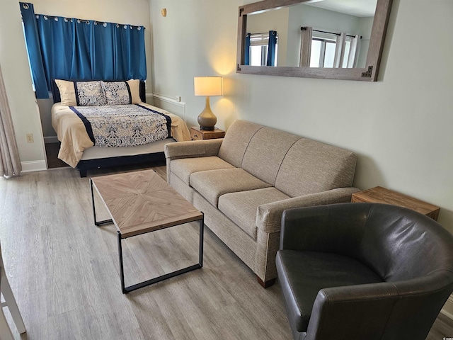 bedroom with baseboards and wood finished floors