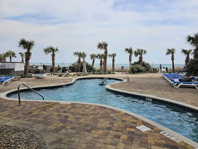 pool with fence and a patio area