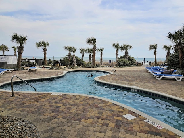 pool featuring a patio area and fence