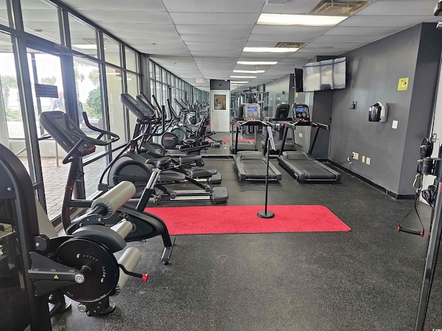 gym featuring a drop ceiling, baseboards, and visible vents