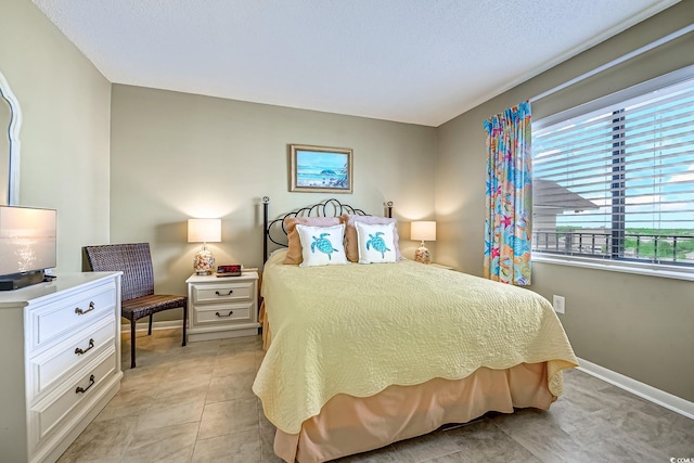 bedroom featuring light tile patterned floors and baseboards