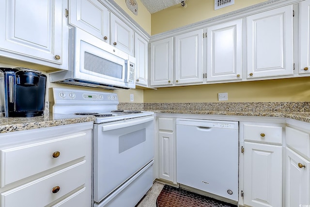 kitchen with visible vents, light stone countertops, tile patterned floors, white appliances, and white cabinetry