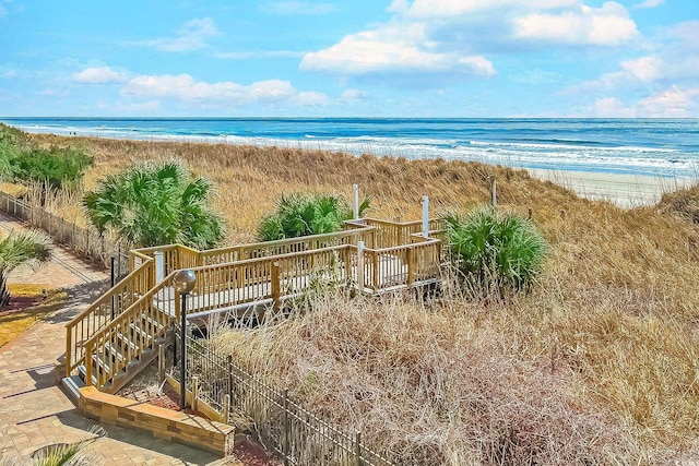 view of water feature featuring stairway and a view of the beach