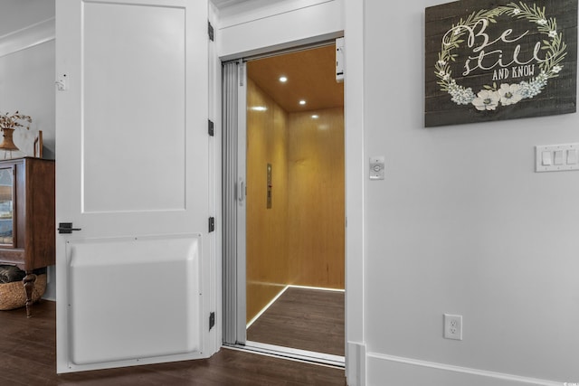 hall featuring elevator and wood finished floors