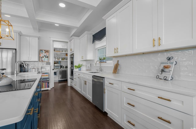 kitchen featuring a sink, blue cabinetry, white cabinets, and stainless steel appliances