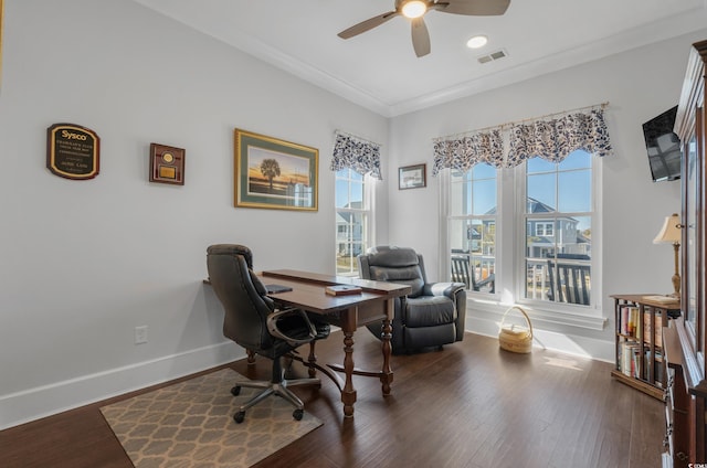 office featuring wood finished floors, a ceiling fan, visible vents, baseboards, and crown molding