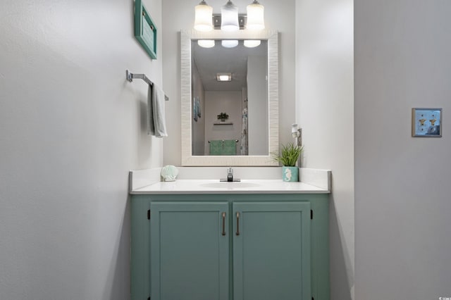 bathroom featuring walk in shower and vanity