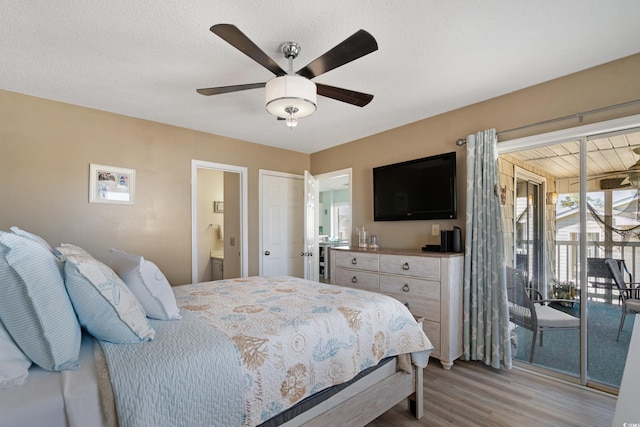 bedroom featuring ensuite bathroom, access to exterior, a textured ceiling, light wood finished floors, and ceiling fan