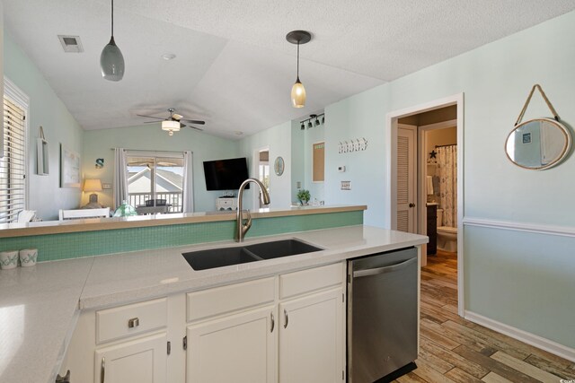 kitchen featuring visible vents, ceiling fan, a sink, dishwasher, and light wood-type flooring