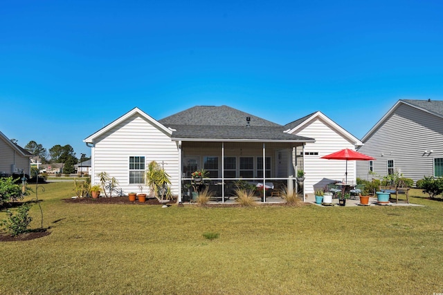 back of house featuring roof with shingles, a yard, and a sunroom