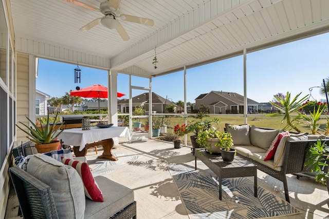 sunroom / solarium with pool table and a ceiling fan