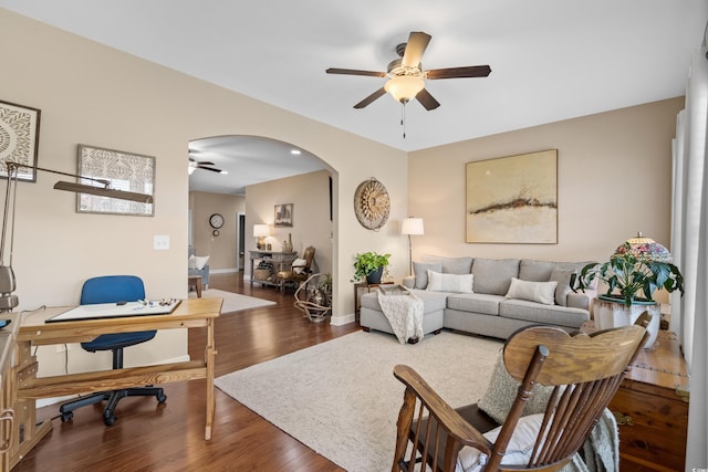 office with wood finished floors, a ceiling fan, arched walkways, and baseboards