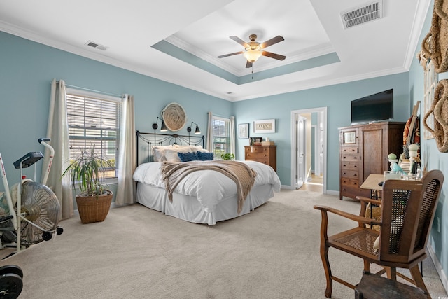 bedroom featuring visible vents, a raised ceiling, and light colored carpet